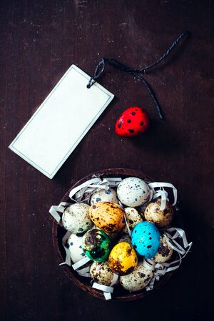 Colorful Easter eggs and blank card on wooden backgroundの写真素材
