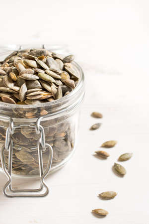 Pumpkin unshelled seeds in the jar,selective focus and blank spaceの写真素材