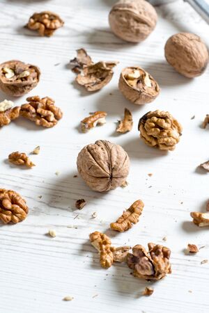 Raw walnuts splashed on table,selective focus in the middle
