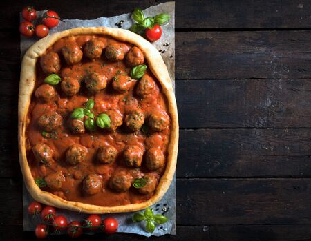 Meatballs and tomato sauce in pastry from above on wooden background,selective focus and blank spaceの写真素材