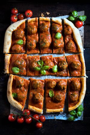 Sliced meatballs pizza from above on wooden background,selective focus