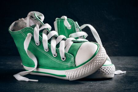 Pair of fashionable sneakers on dark background,selective focusの写真素材