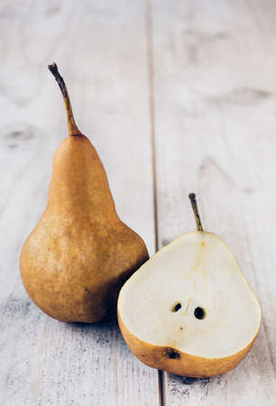 Sliced pear and whole on woden backgound,selective focusの写真素材