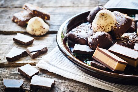 Sweet pralines and chocolate cookies in the plate,selective focus