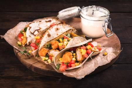 Traditional Mexican tortilla sandwiches with fried chicken meat and vegetables,selective focusの写真素材