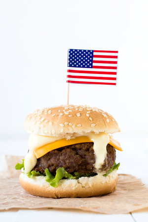 Single American mini beef burgers with cheese and USA flags,selective focusの写真素材