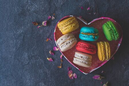 Sweet homemade macaroons cookies in heart shape box,selective focus and blank spaceの写真素材
