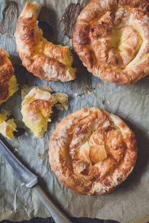 Mini cheese pies on old paper background from aboveの写真素材