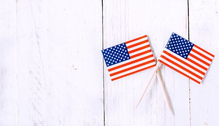 Sticks with American flag on white wooden background,blank space on the left sideの写真素材