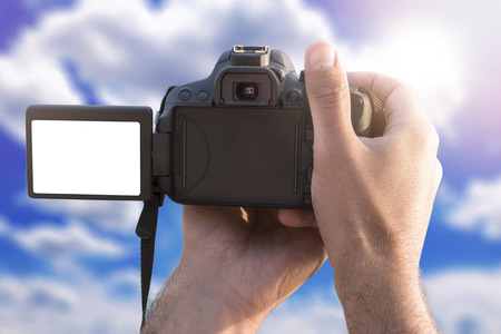 Man holding camera with blank screen and take a photoの写真素材
