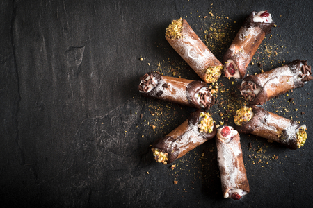 Homemade traditional Sicilian sweet cannoli stuffed ricotta cheese cream,selective focus and blank spaceの写真素材