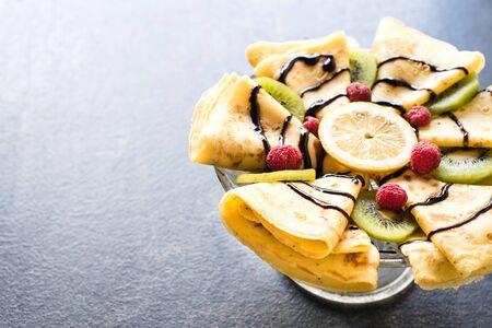 Traditional homemade flapjacks with chocolate cream and fruits,selective focus and blank spaceの写真素材