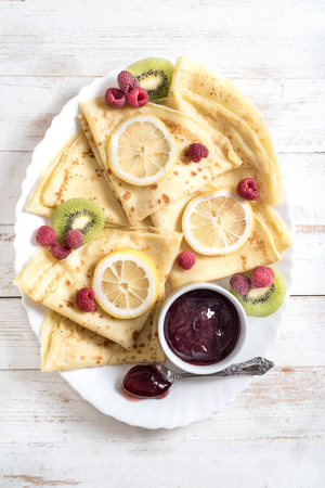 Homemade flapjacks with raspberries jam served on the plate, from aboveの写真素材
