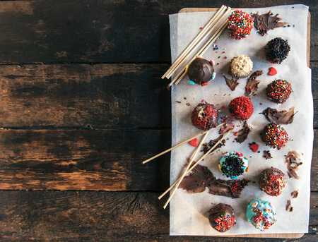 Sweet and homemade chocolate cake pops on wooden background,blank spaceの写真素材