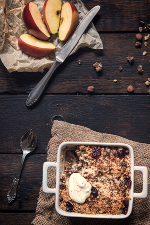 Homemade sweet apple crumble cake from above on dark wooden backgroundの写真素材