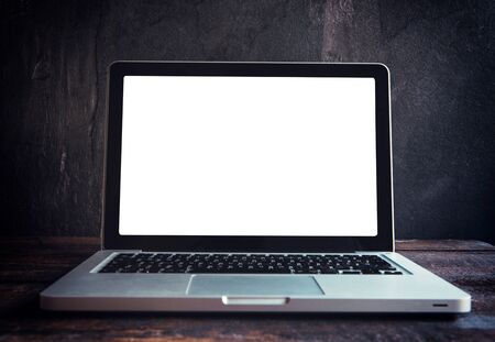 Laptop computer with blank screen on wooden background