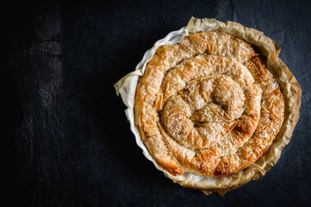 Homemade potatoes pie on dark background with blank space