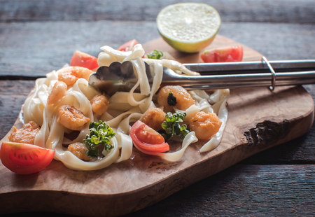 Cooked Pasta tagliatelle and schrimp on wooden board,selective focusの写真素材