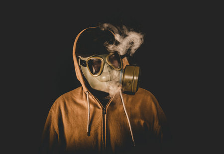 Man wearing mask and smoking,low key