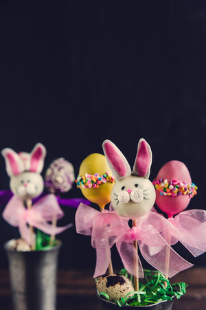 Easter concept with cake pops on dark background with copy spaceの写真素材