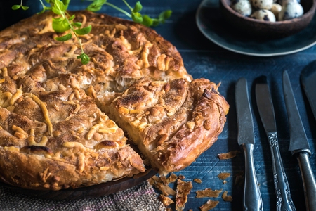 Homemade and baked double cheese pie on blue wooden background,selective focusの写真素材