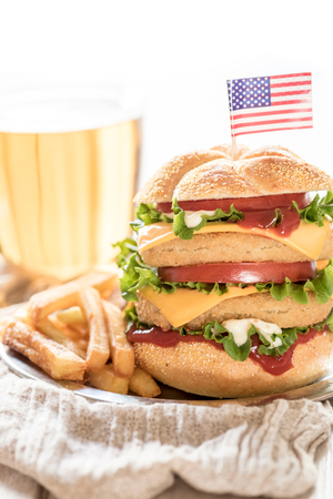 Double fish burger with french fries and USA flag on the top,selective focusの写真素材