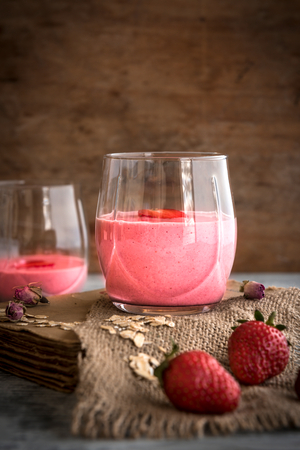 Strawberry smoothie in the glass on book,selective focusの写真素材