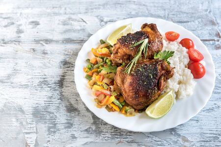 Marinated chicken meat and vegetables in the plate on wooden table,empty spaceの写真素材