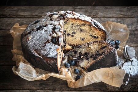 Sliced homemade bluberry cake on wooden background,selective focusの写真素材