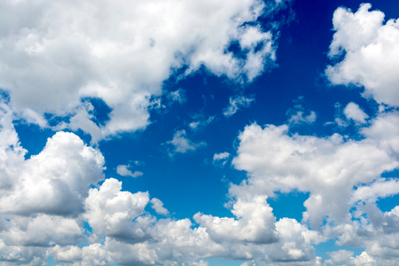 Fluffy white clouds and blue skyの写真素材