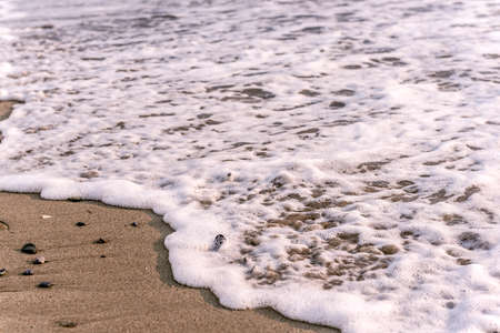 Close up to sea foam at the beach