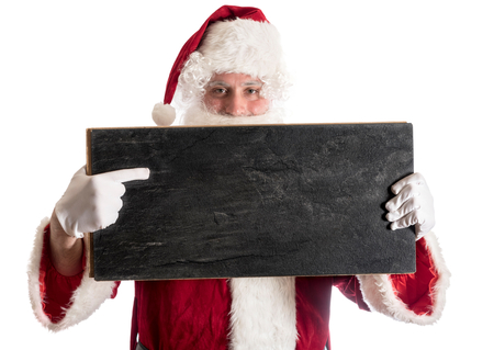 Happy Santa Claus holding and pointing on blank chalkboard,isolated on white backgroundの写真素材