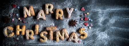 Merry Christmas concept with cookies on dark background with blank spaceの写真素材