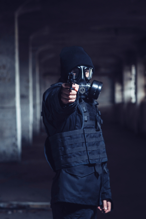The terrorist with gas mask pointing gun,selective focusの写真素材