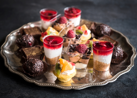 Served assorted of chocolate and fruit mini cakes for holiday,selective focusの写真素材