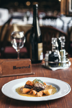Served roasted beef and potatoes on the table,selective focusの写真素材