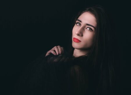 Low key portrait of woman on the dark backgroundの写真素材
