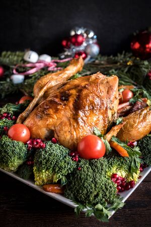 Served whole roasted chicken with vegetables,selective focusの写真素材