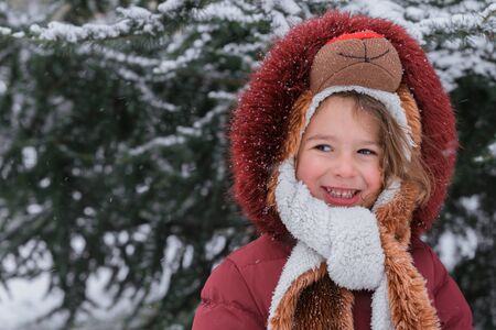 Positive child portrait with snow in background の写真素材
