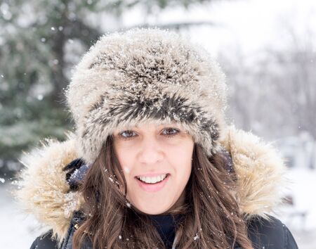 Portrait of positive female during the snow stormの写真素材