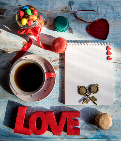 Cup of dark coffee and candies,love concept with blank bookの写真素材