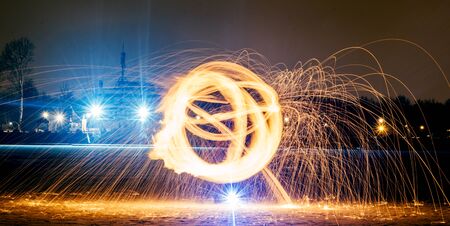 Long exposure photography with the fire ball at nightの写真素材