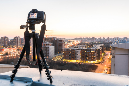 Camera on tripod shooting the city landscape at dusk,selective focusの写真素材