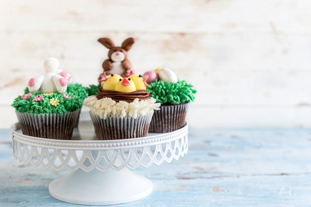 Served Easter cup cakes on wooden background with blank space,selective focusの写真素材