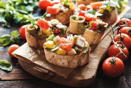 Traditional Italian bruschettas served on wooden board,selective focusの写真素材