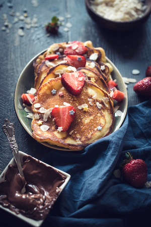 Sweet homemade pancakes with melted chocolate and strawberries in the plate,selective focusの写真素材