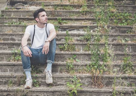 Young fashion mans legs in jeans and shoes on the stairs ,selective focusの写真素材