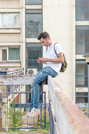 Handsome man typing on the phone,selective focusの写真素材
