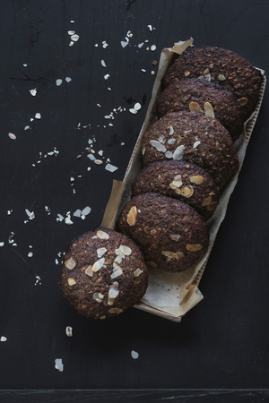 Packed oats and chocolate cookies on dark backgroundの写真素材