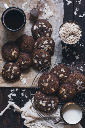 Chocolate and oats cookies served with milk and coffeeの写真素材